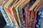 Close-up of a handloon saree's intricate patterns and vivid colors displayed on a wooden hanger.