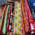 a bunch of different colored ties hanging on a rack