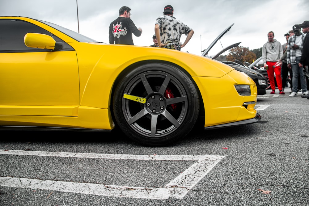 a yellow sports car parked in a parking lot