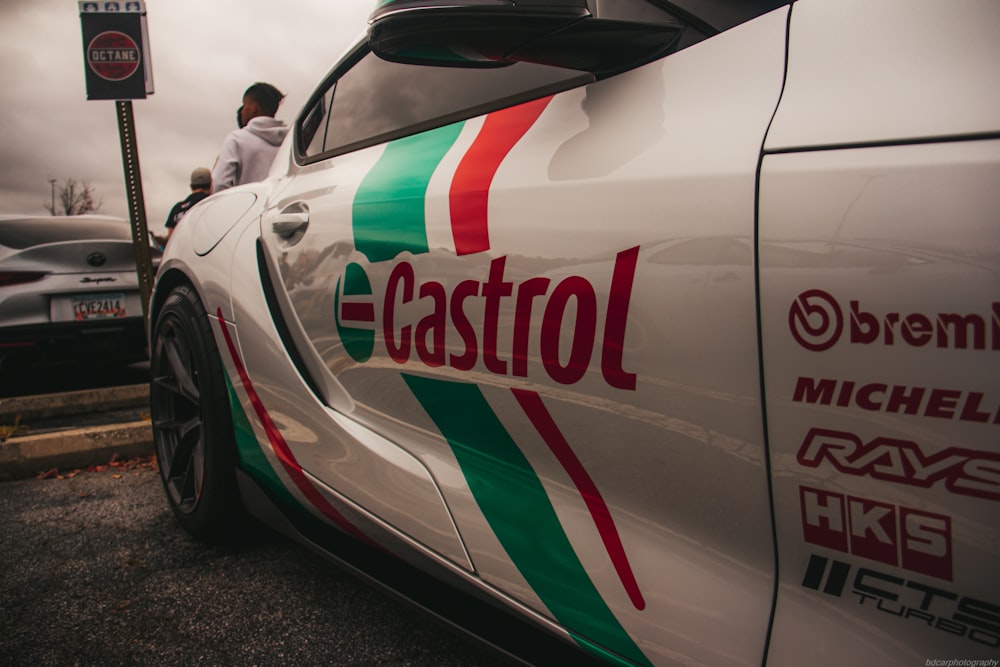 a white car with a red, green and white stripe on it