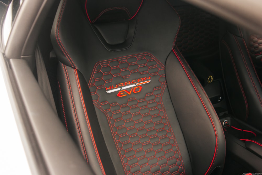 a close up of a car's interior with red stitching
