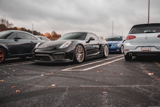 a group of cars parked in a parking lot all on long distance touring tyres