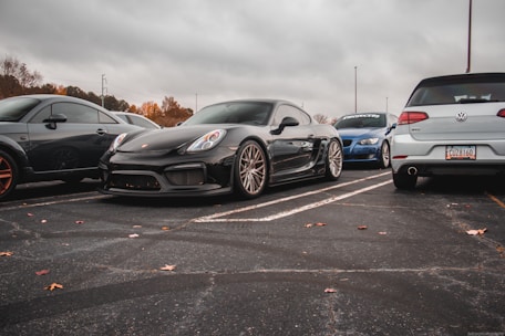 a group of cars parked in a parking lot all on long distance touring tyres