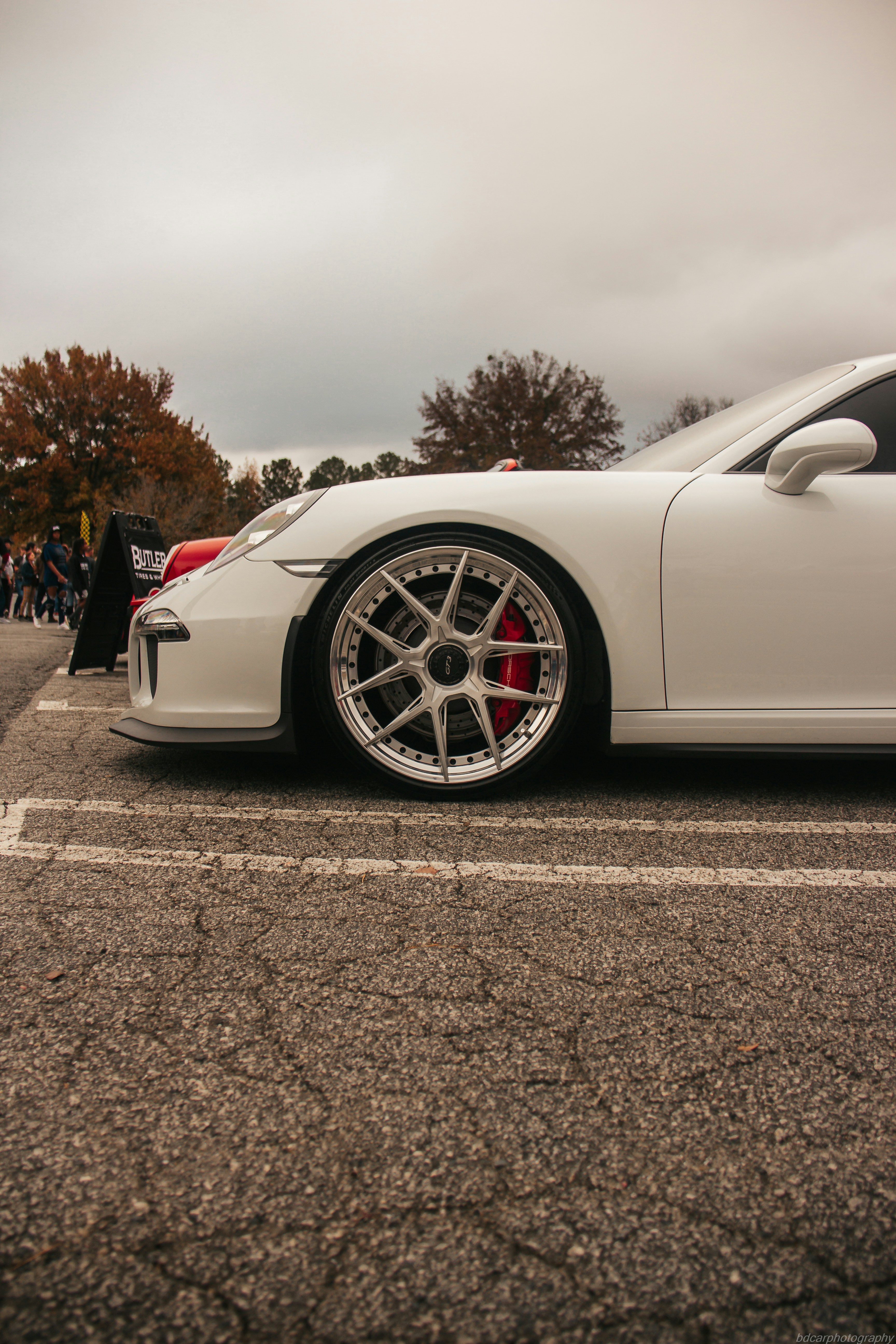 a white sports car parked in a parking lot
