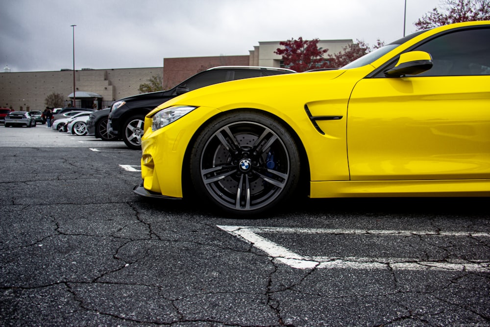 a yellow car parked in a parking lot