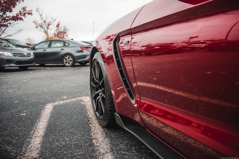 a red sports car parked in a parking lot