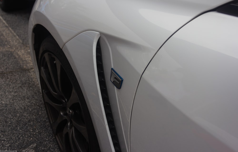 a close up of the front of a white sports car