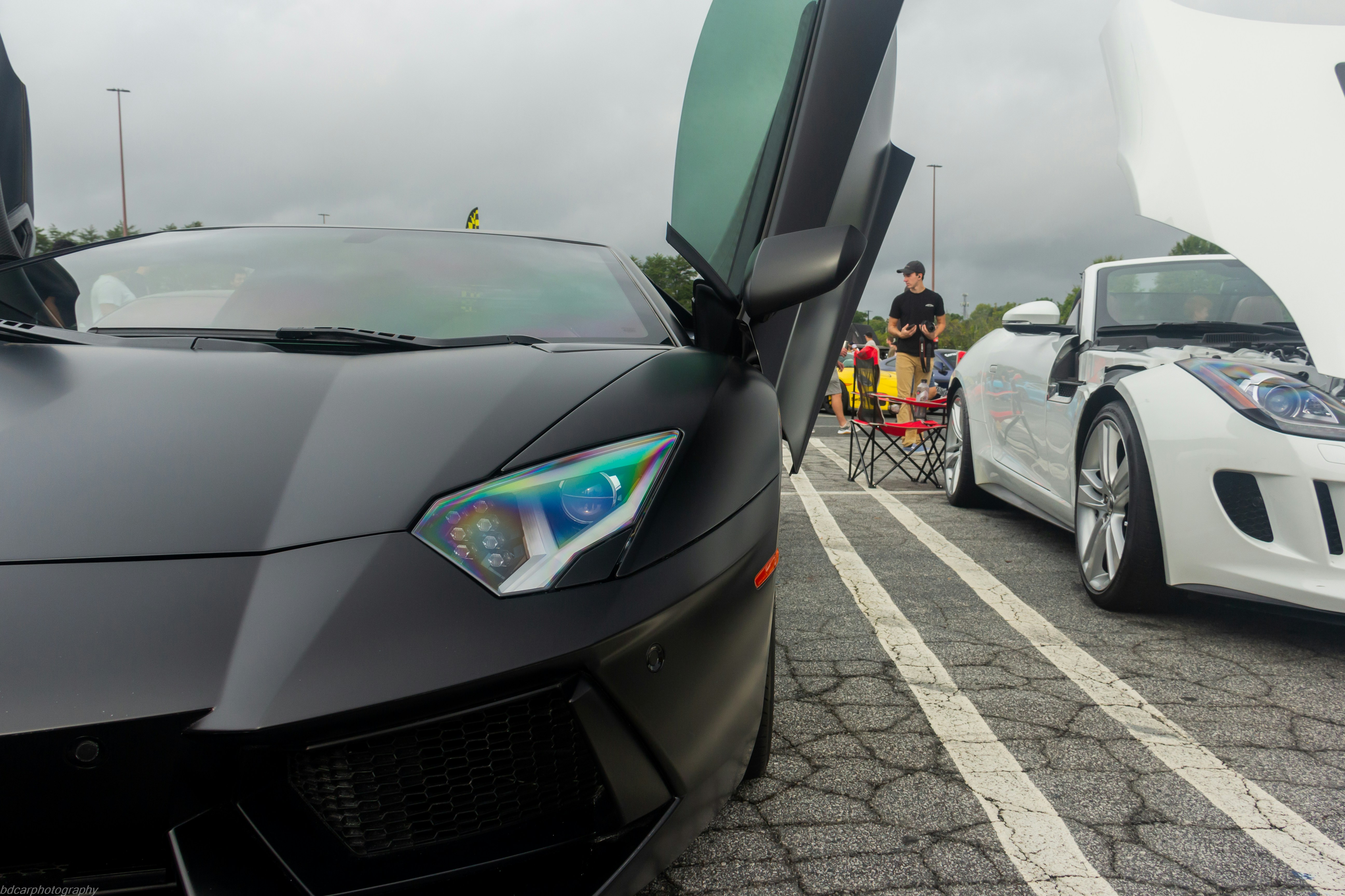 a black sports car parked next to a white sports car