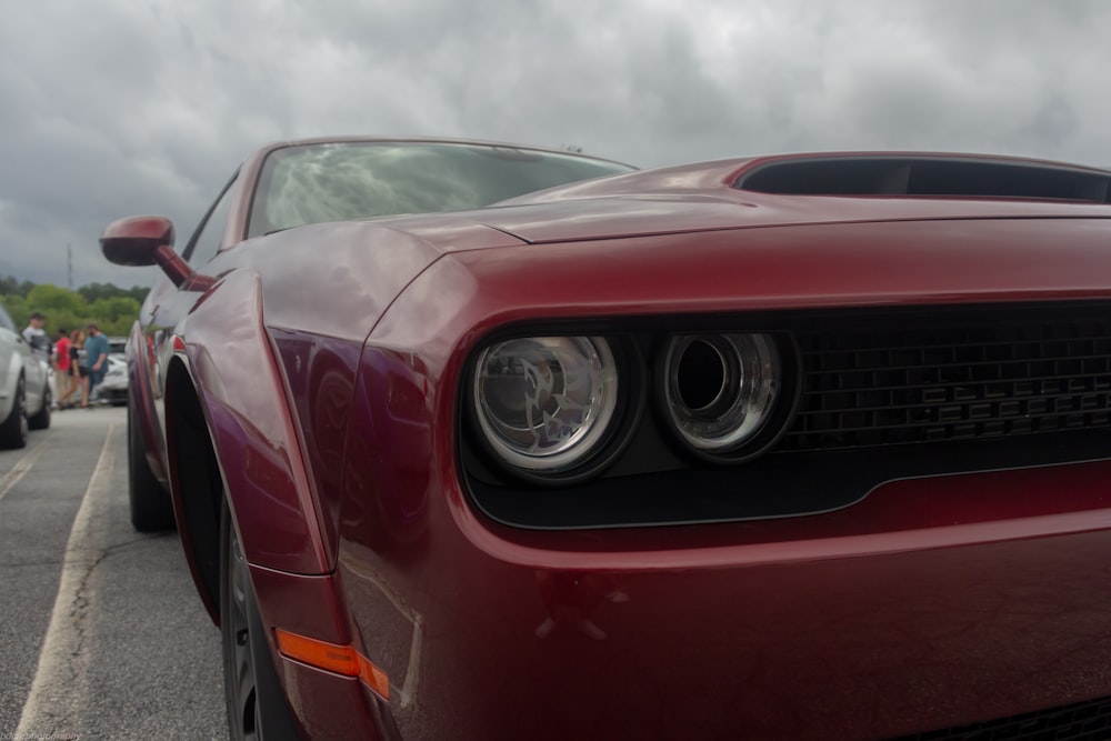 a close up of the front of a red sports car