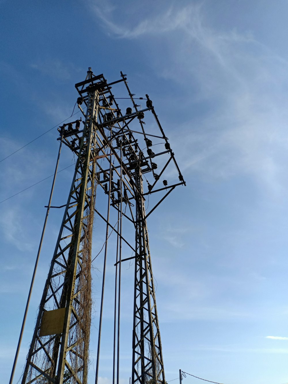 a tall tower with lots of wires on top of it