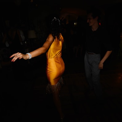 Ethyl dancing joyfully under a spotlight, her dress swirling in a smooth animation style.