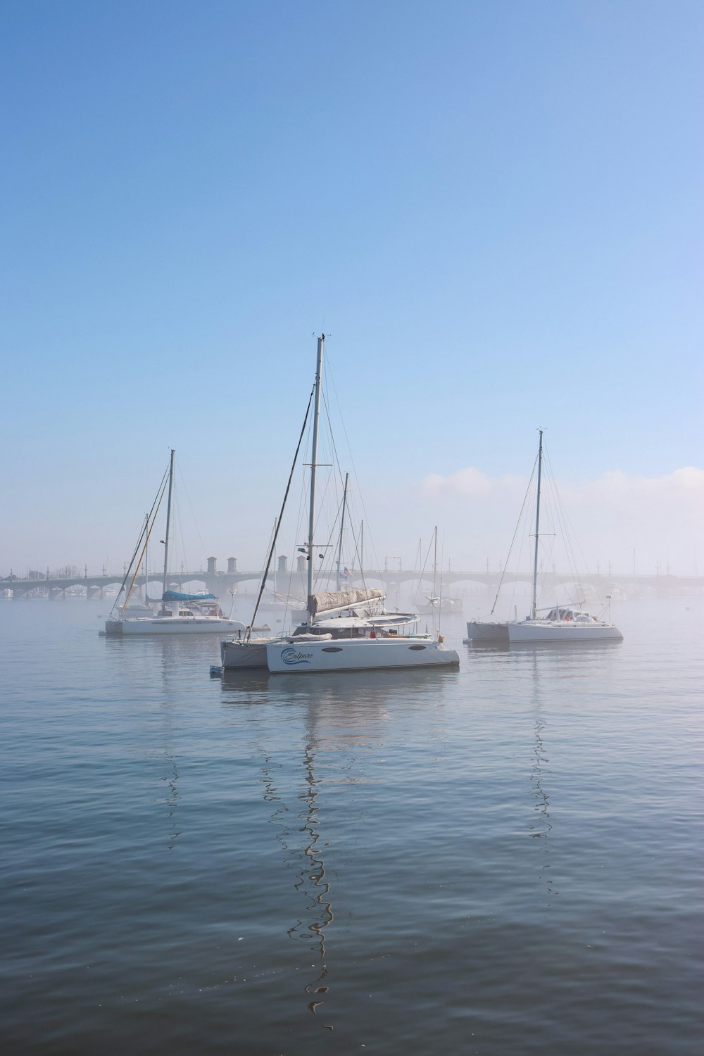 a group of boats floating on top of a body of water