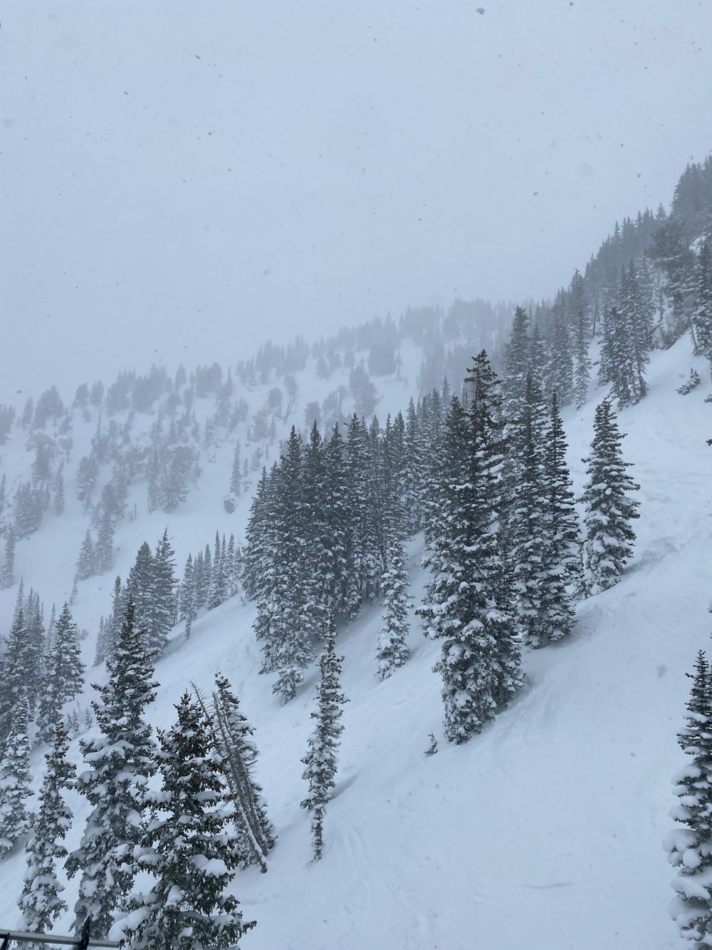 a snow covered mountain with a ski lift in the foreground