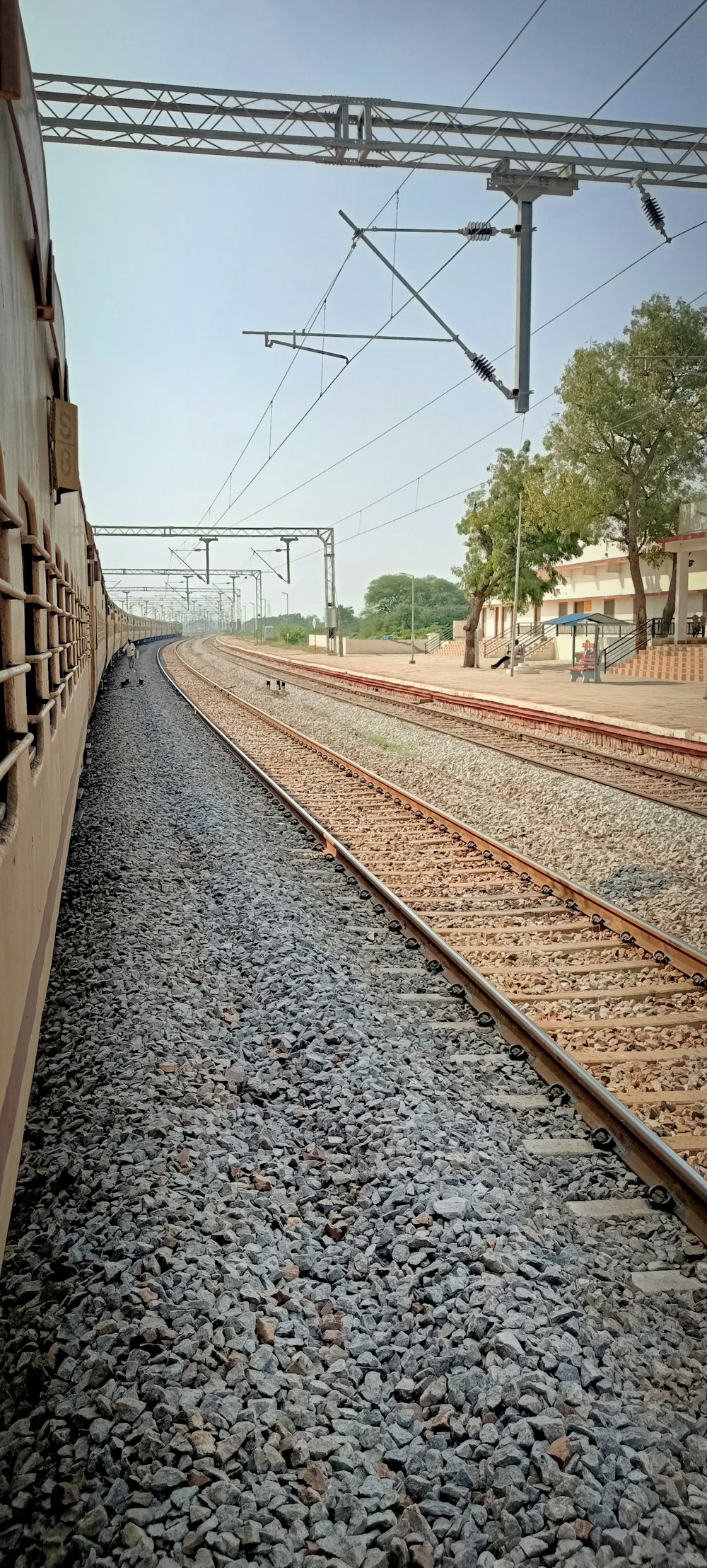 a train traveling down train tracks next to a train station