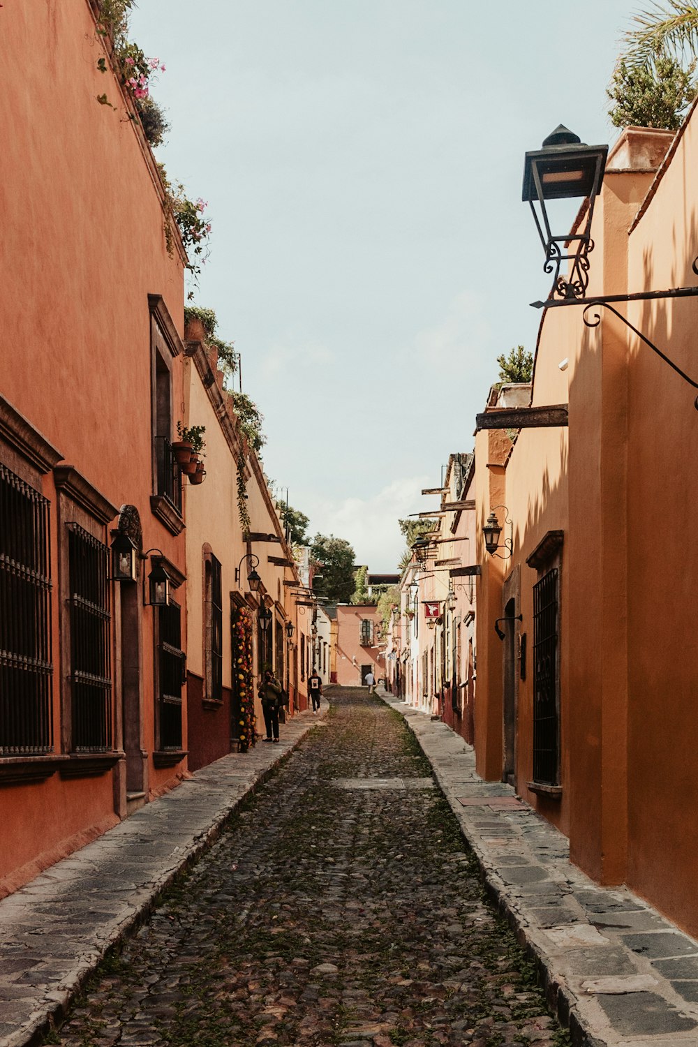 a narrow cobblestone street in an old town