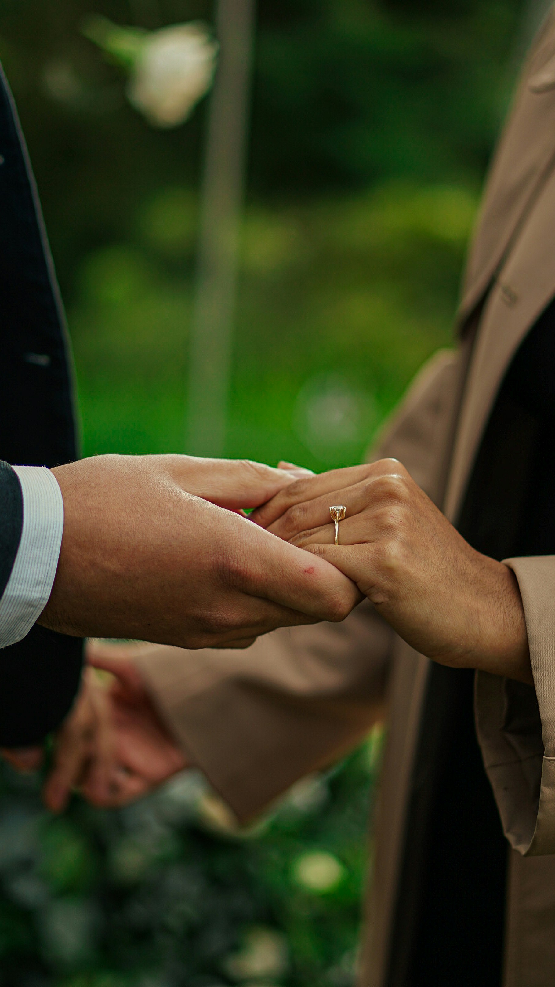 a close up of two people holding hands