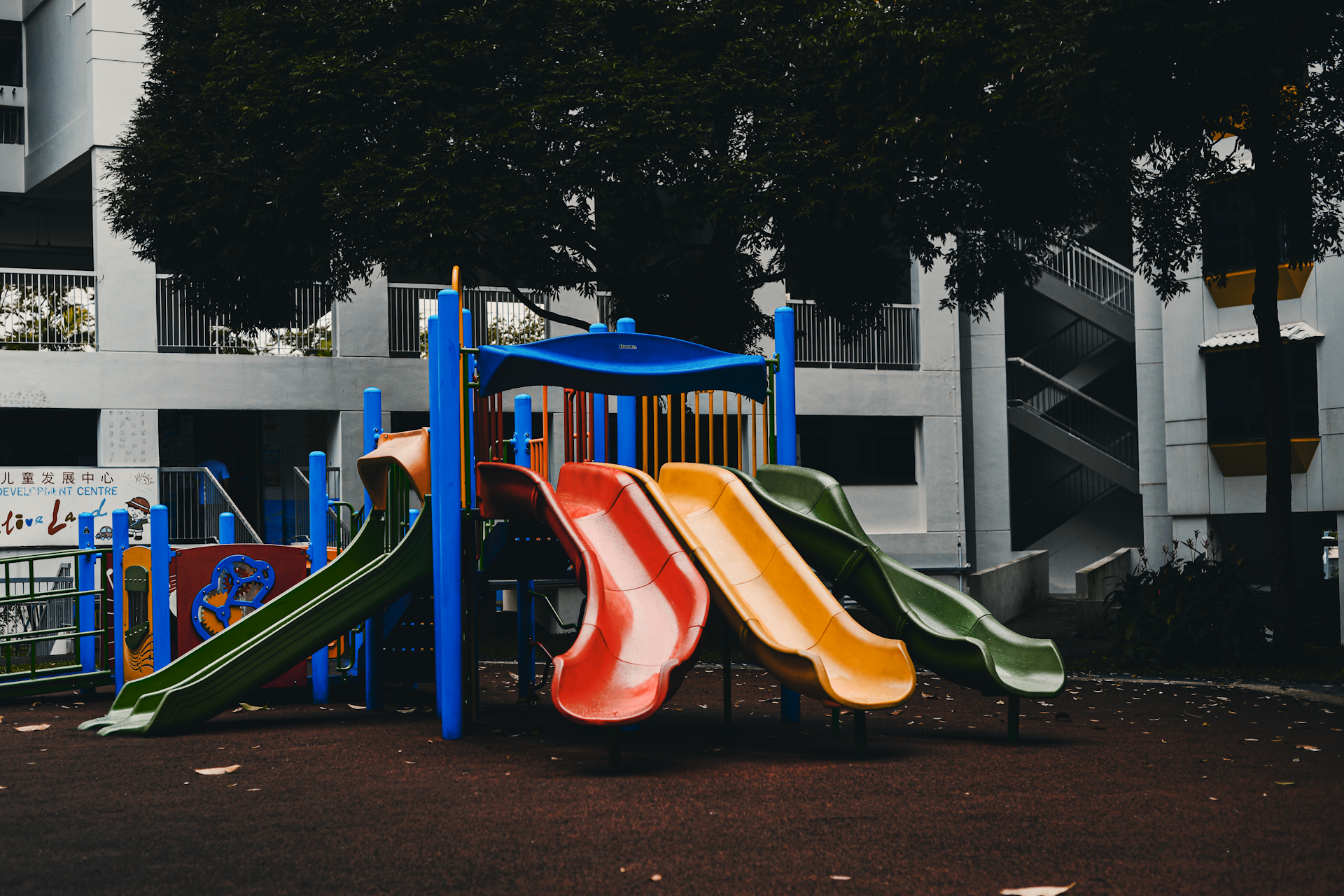 a children's play area with a slide and climbing frame