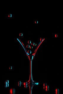 Close-up of a signature glowing cocktail with galaxy-inspired colors and sparkling effects.