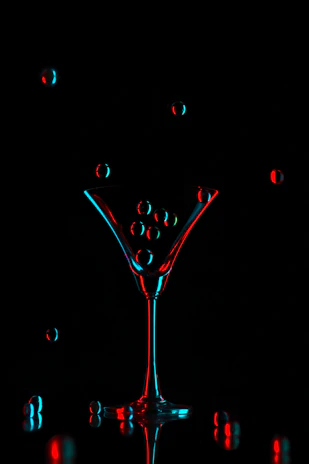 Close-up of a signature glowing cocktail with galaxy-inspired colors and sparkling effects.