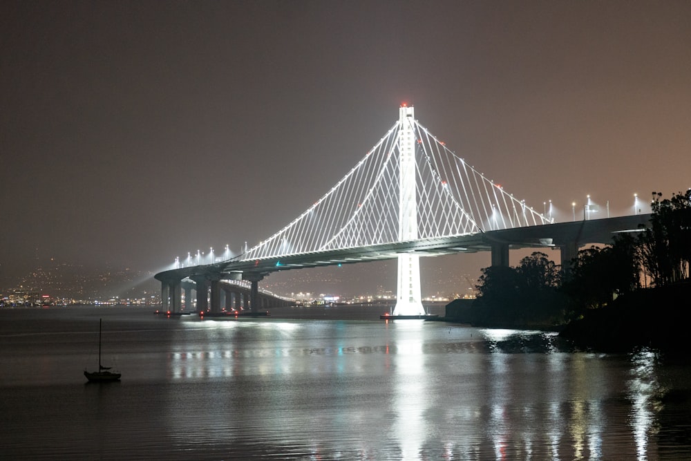 a large bridge over a body of water at night