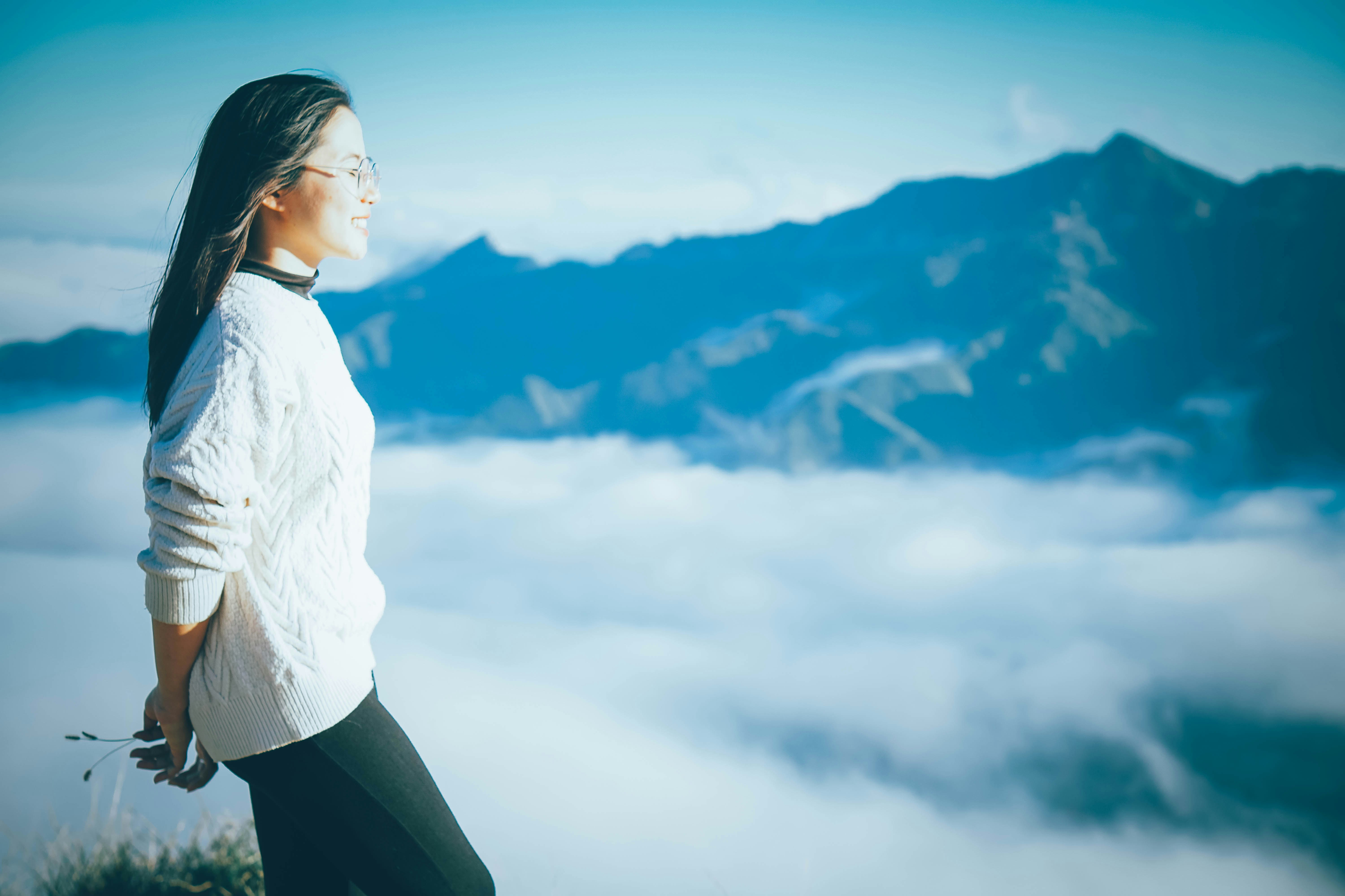 Hiking safety tips for solo female hikers - Woman conquering mountain peaks