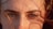 A close-up of a person's eyes and eyebrows, with sunlight casting shadows and highlighting the natural texture of the skin and hair.