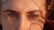 A close-up of a person's eyes and eyebrows, with sunlight casting shadows and highlighting the natural texture of the skin and hair.
