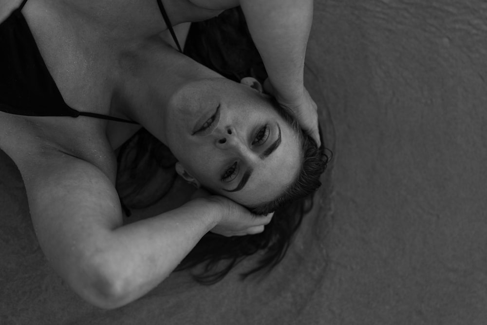 a black and white photo of a woman in a bikini