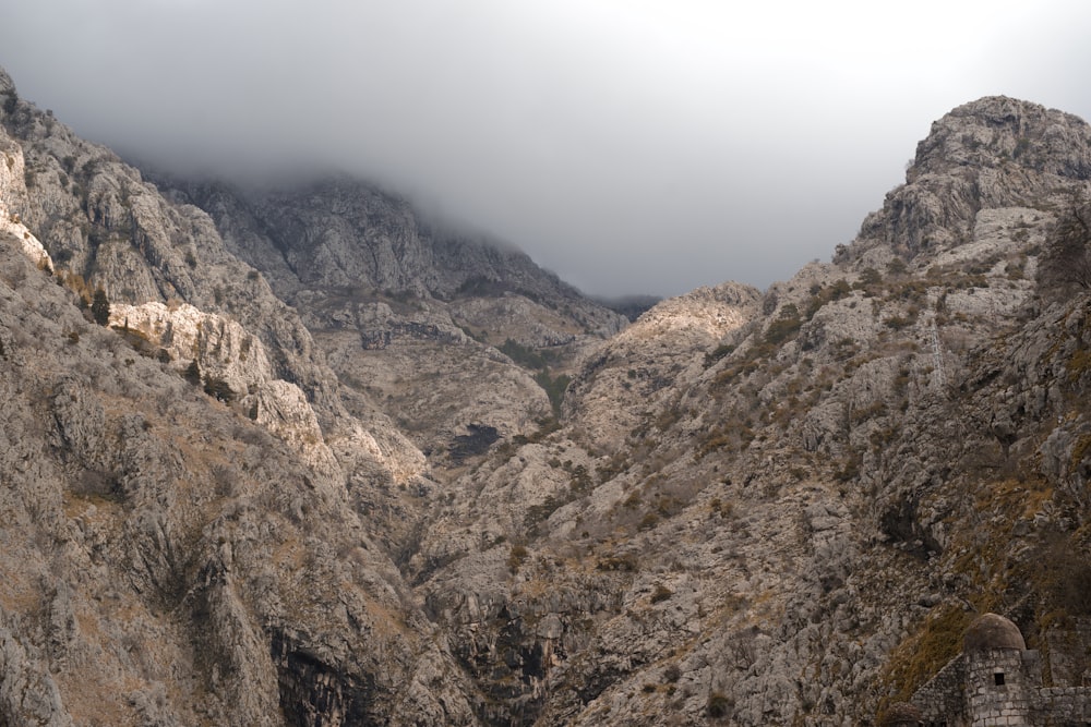 a view of a mountain range from the top of a hill