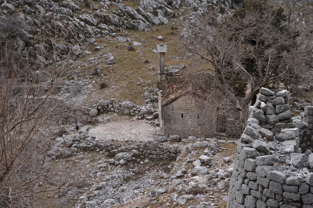 a stone building sitting on top of a rocky hillside