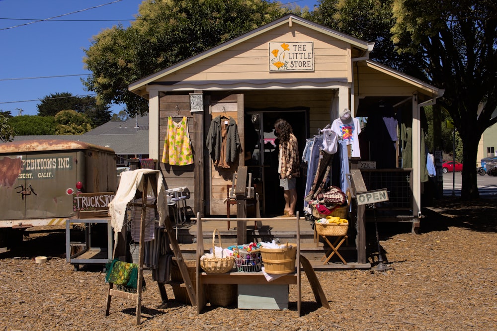 a small shed with clothes hanging outside of it