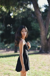A model wearing a casual dress in a park.