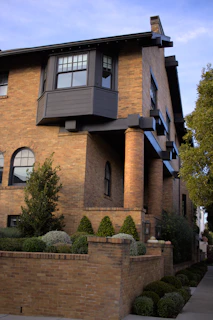 a tall brick building with a clock on the front of it