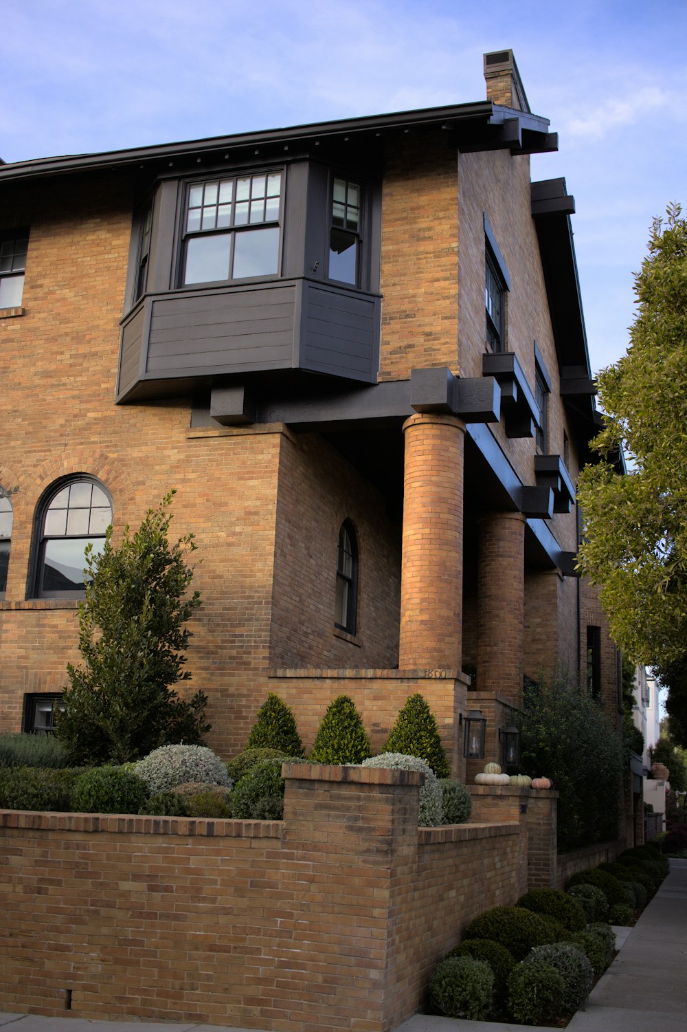 a tall brick building with a clock on the front of it