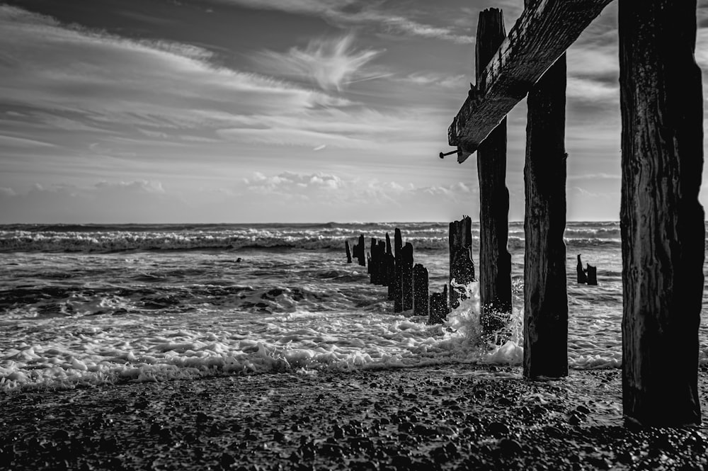 a black and white photo of a wooden pier