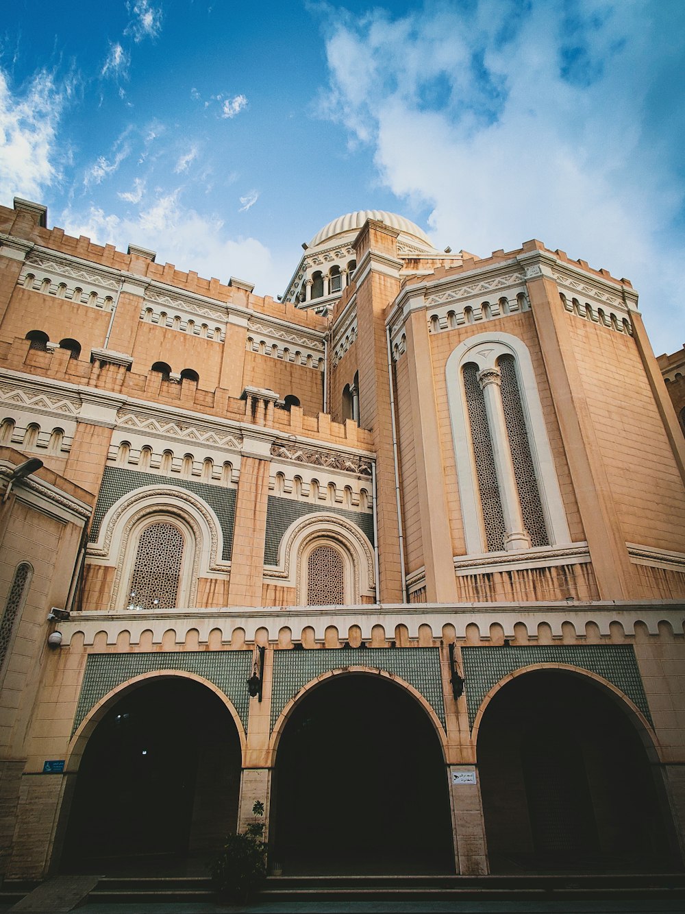 a large building with arches and a clock tower