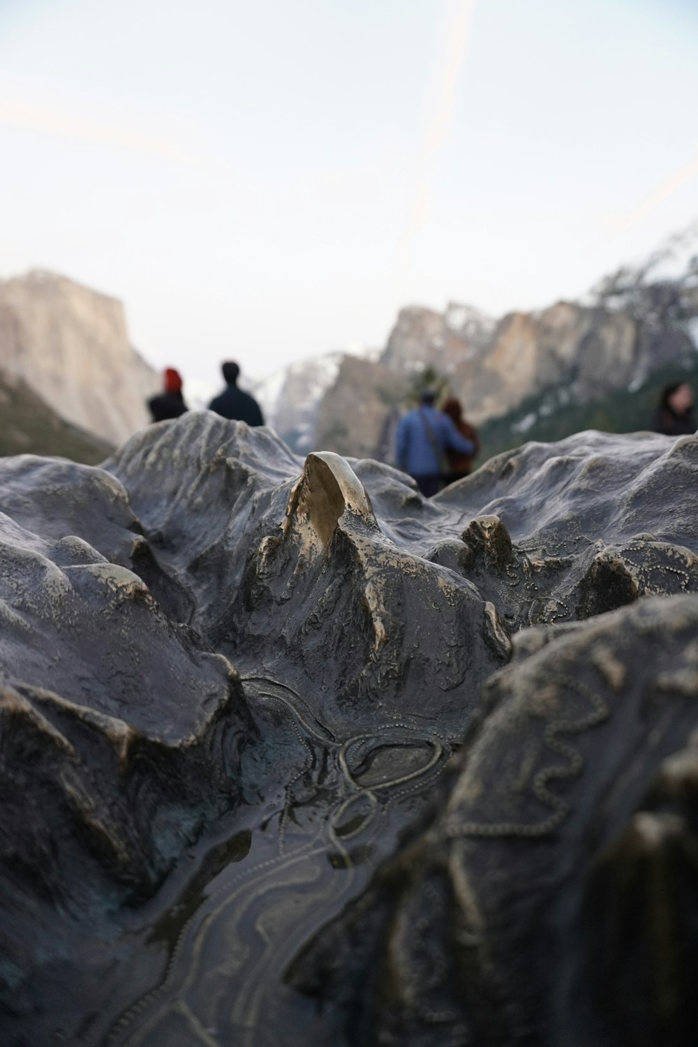 a group of people sitting on top of a mountain