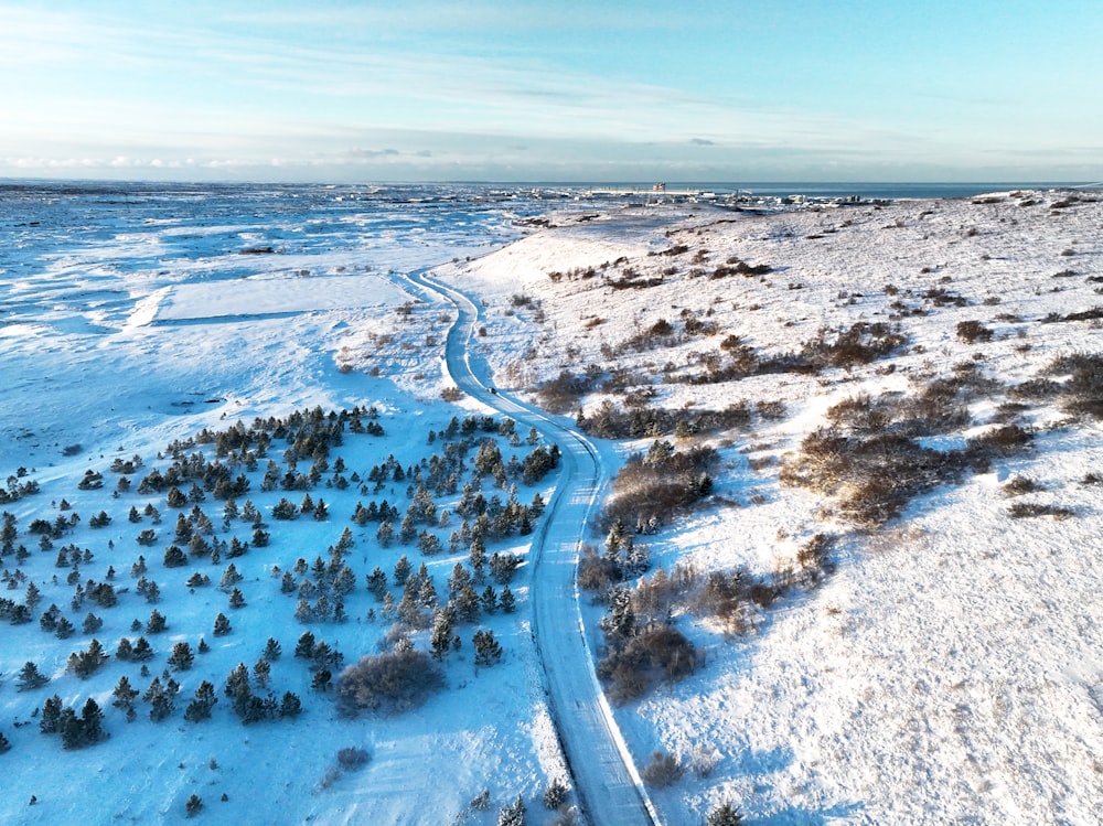 an aerial view of a snow covered field