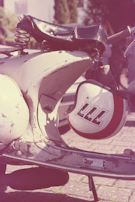 A close-up of a comfortable motorcycle seat with a helmet resting on it.