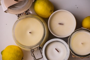 three lemons and two candles on a table