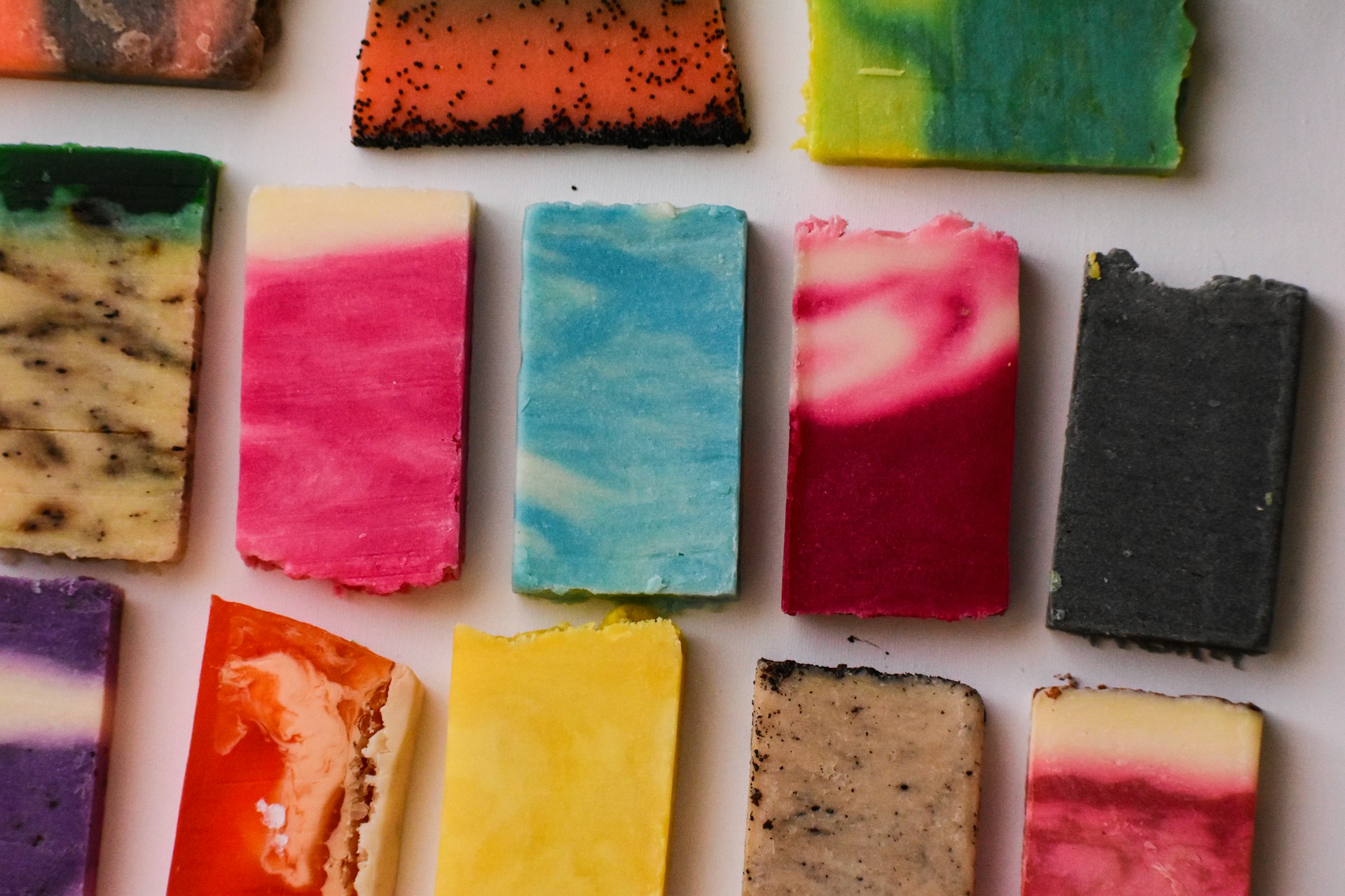 a bunch of different colored bars of soap