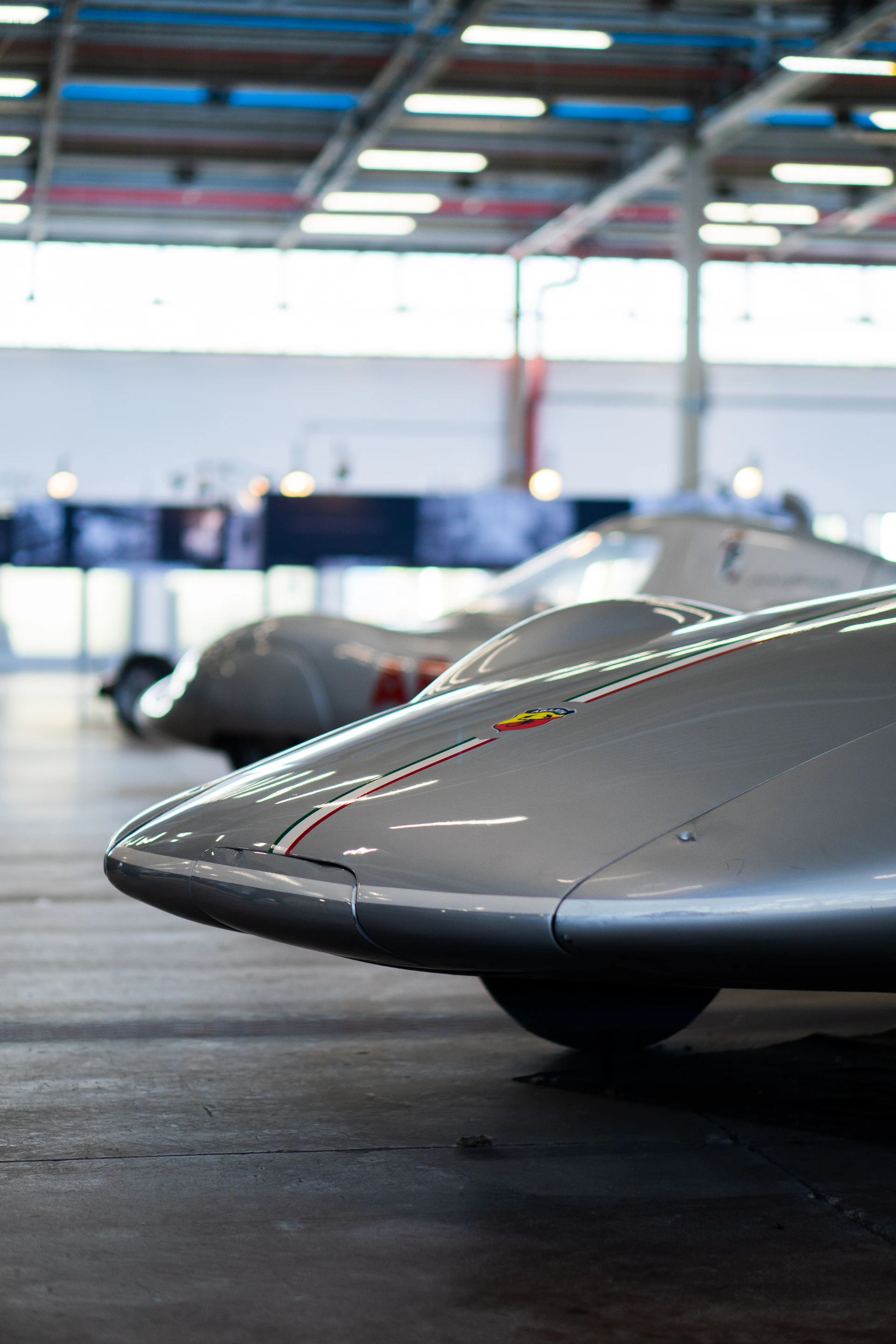 a row of cars parked inside of a garage