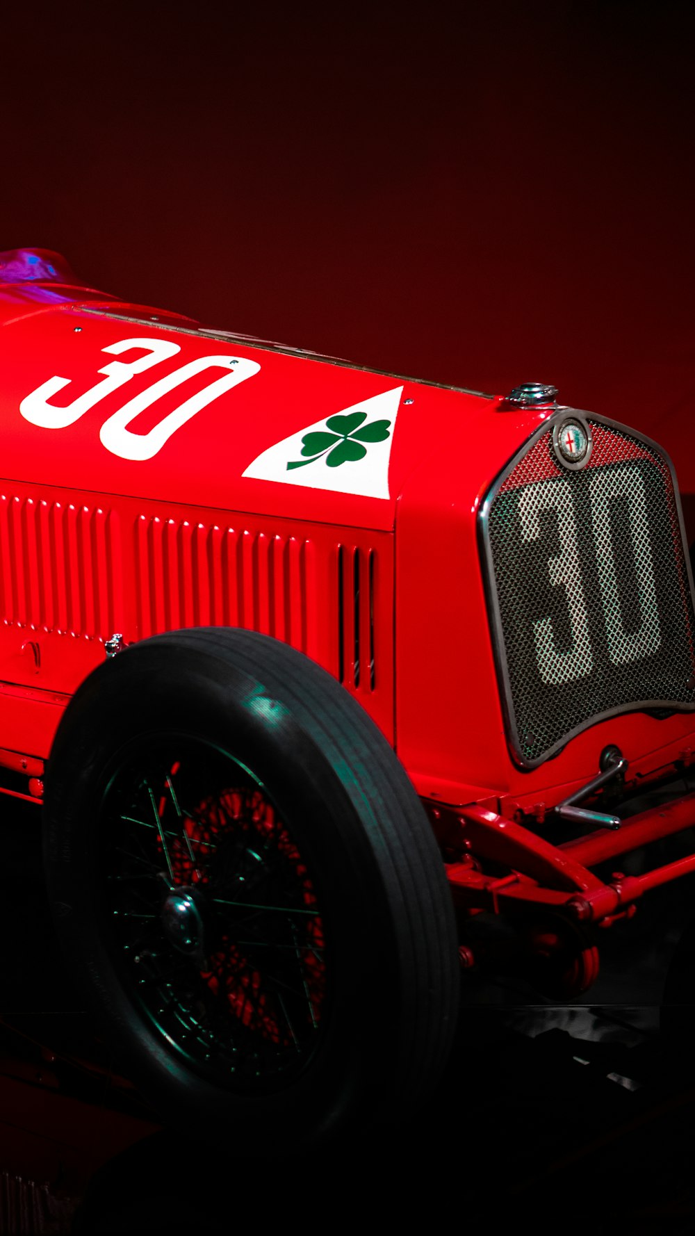 a red race car with a number on the side