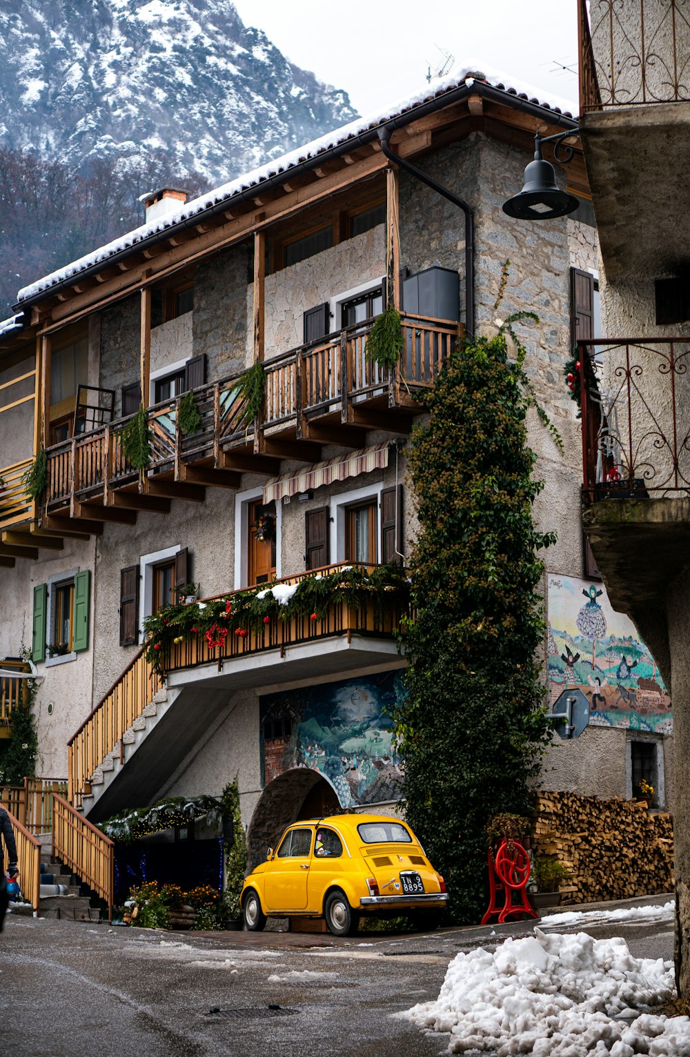 a yellow car parked in front of a building