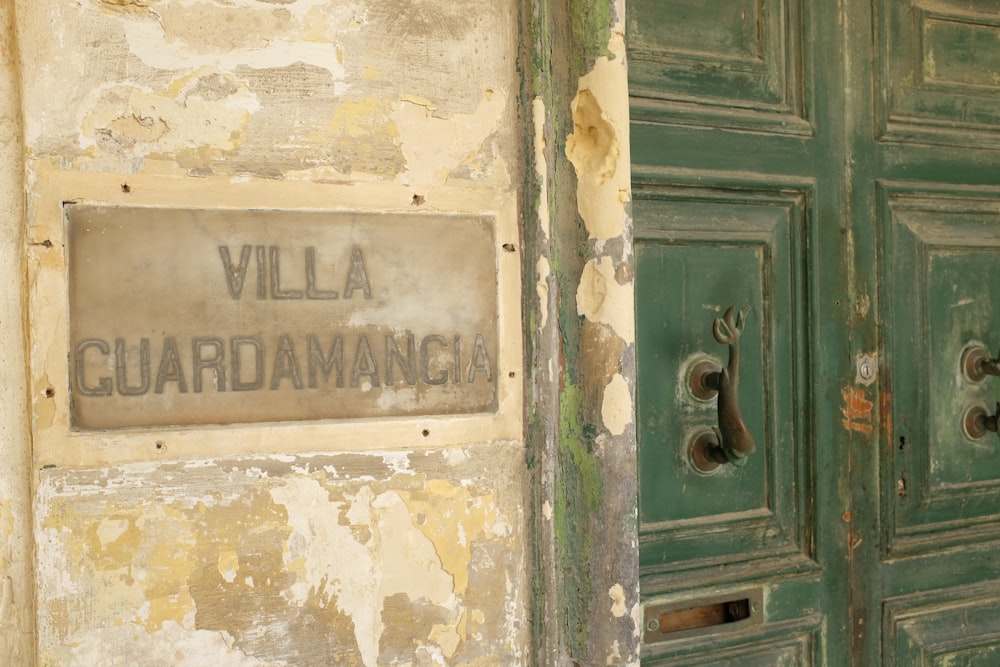 a green door with a sign on it