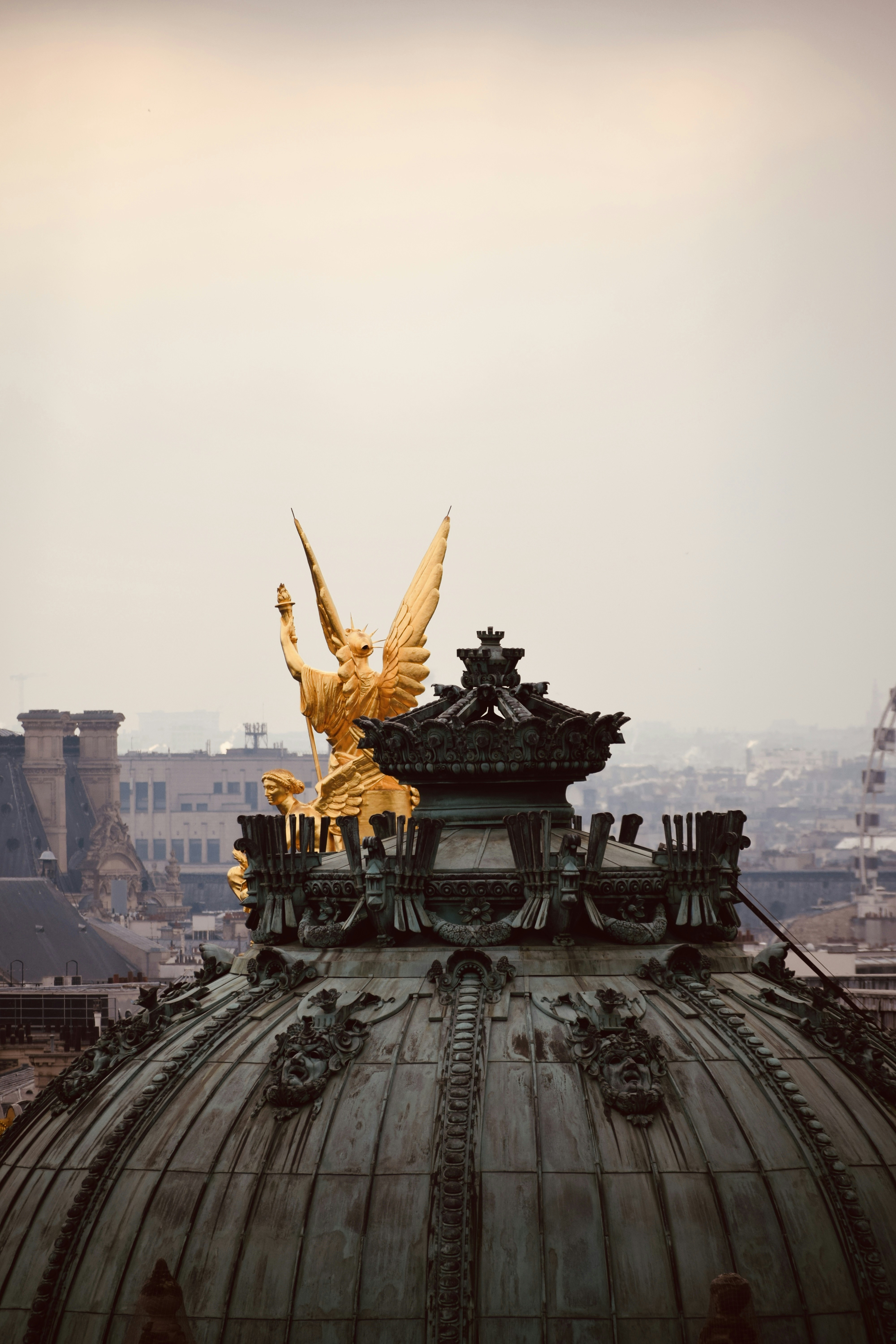 a golden statue on top of a building