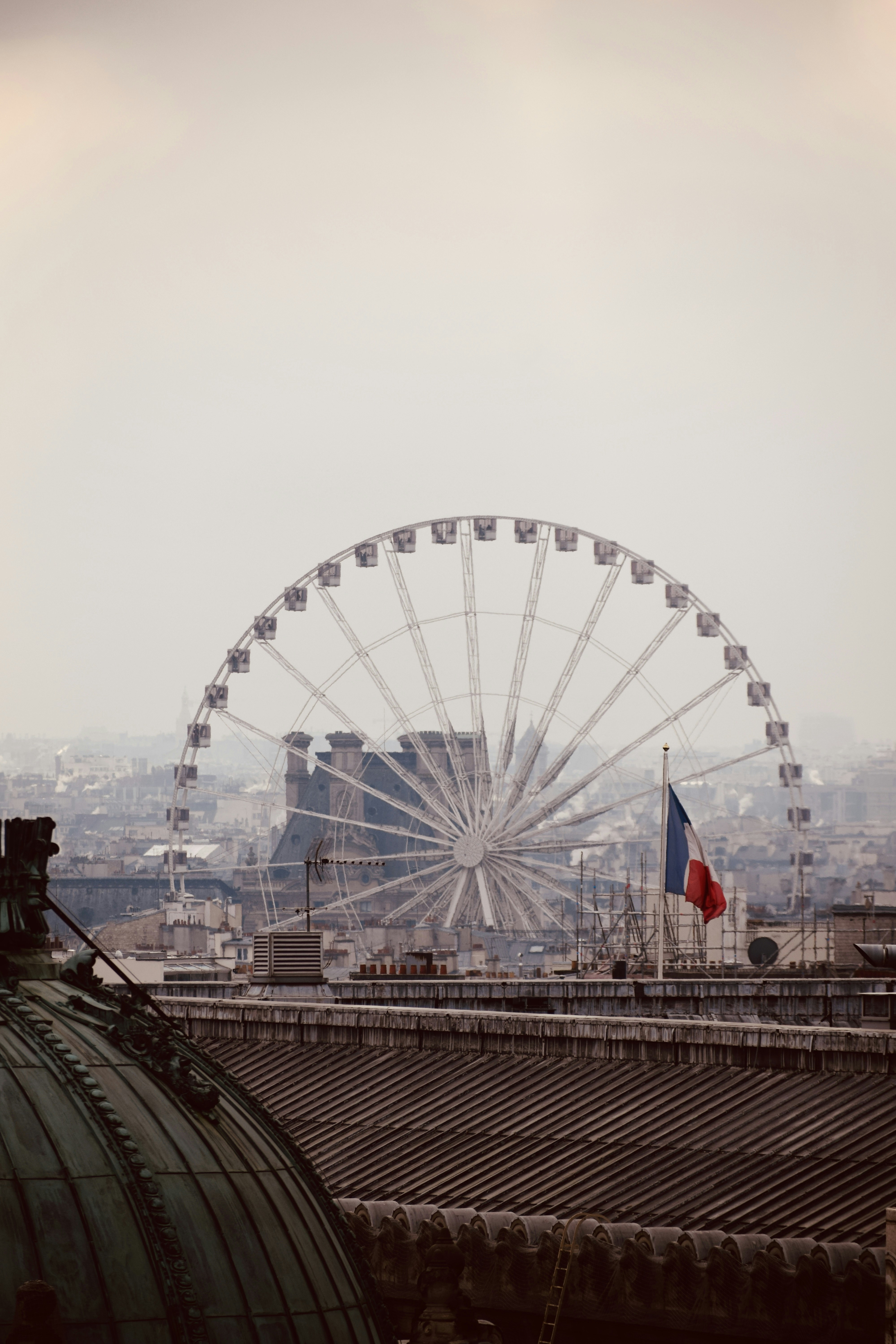 A large ferris wheel on top of a building photo – Free Paris Image on ...