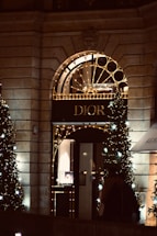 Elegant storefront of deivia extra with dark black and gold accents at dusk.