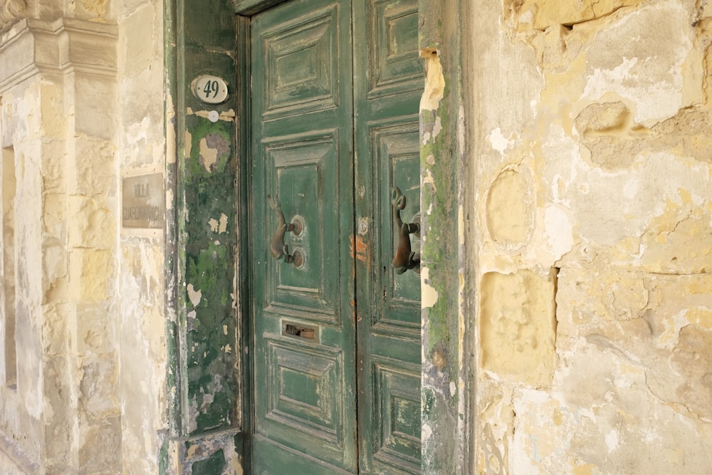 a green door is open in an old building