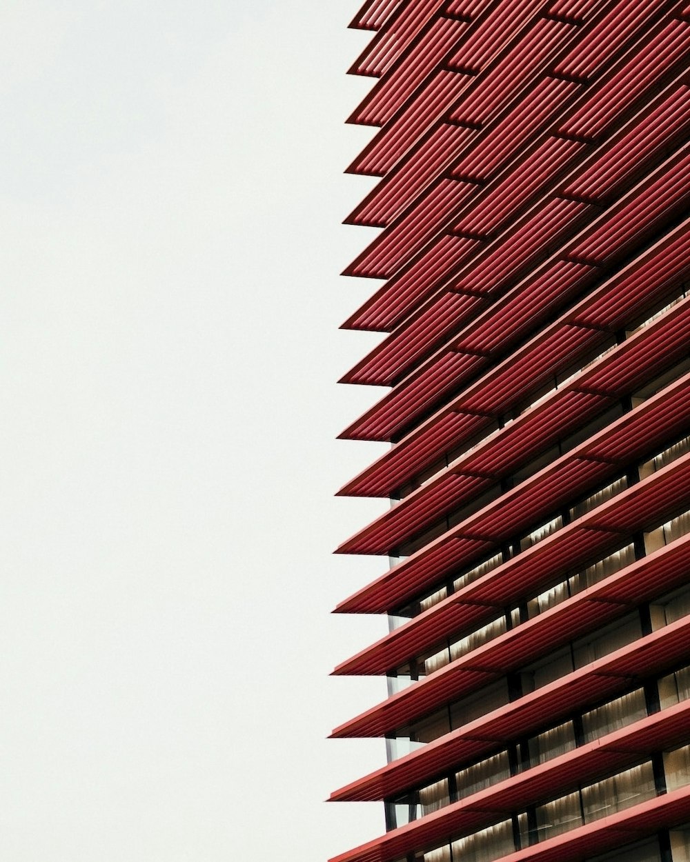 a tall red building with a clock on it's side